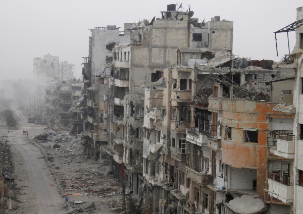 "Smoke rises from buildings after what activists said was shelling from forces loyal to President al-Assad in besieged area of Homs"